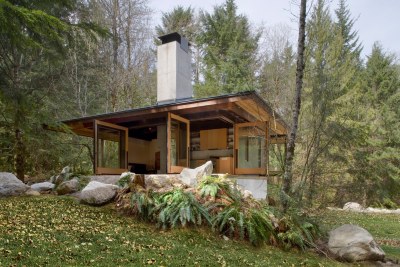 archatlas:<br /><br /><br /><br />Tye River Cabin Olson KundigSituated in a dense forest near the Tye River, this meditative retreat connects to the nature that surrounds it.The square base of the two-level structure is rendered in cast-in-place concrete, as is the large central fireplace that serves as the core and anchor for the cabin. Custom-designed, pivoting glass windows swing open to reveal the corners and sides of the space, blurring the line between inside and outside. Rusted mild steel siding wraps the exterior areas not given over to windows. Deep overhangs shelter the main living area from the regular rain showers. Concrete patios extend the living space outdoors and follow the contours of the land toward the water.Images and text via<br /><br /> Olson Kundig<br /><br />