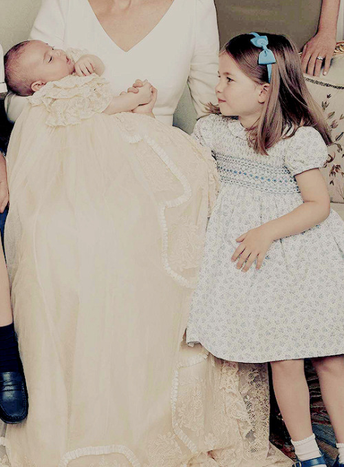 Princess Charlotte holding Prince Louis’ hand in one of...