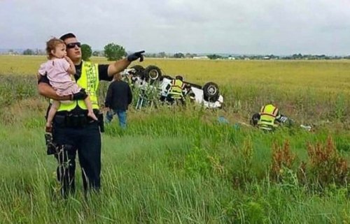 congenitaldisease:A police officer distracting a little girl...