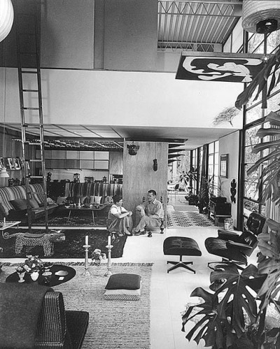 archatlas:<br /><br />Eames House Charles and Ray Eames<br /><br /><br /><br /><br />The Eames House, Case Study House #8, was one of roughly two dozen homes built as part of The Case Study House Program. Begun in the mid-1940s and continuing through the early 1960s, the program was spearheaded by John Entenza, the publisher of Arts and Architecture magazine.In a challenge to the architectural community, the magazine announced that it would be the client for a series of homes designed to express man’s life in the modern world. These homes were to be built and furnished using materials and techniques derived from the experiences of the Second World War. Each home would be for a real or hypothetical client taking into consideration their particular housing needs.<br />The first plan of the Eameses’ home, known as the Bridge House, was designed in 1945 by Charles Eames and Eero Saarinen. The design used pre-fabricated materials ordered from catalogues, a continuation of the idea of mass-production. Charles and Ray moved into the House on Christmas Eve, 1949, and lived there for the rest of their lives.  The interior, its objects and its collections remain very much the way they were in Charles and Ray’s lifetimes.  The house they created offered them a space where work, play, life, and nature co-existed. <br />Images via + via + via<br />