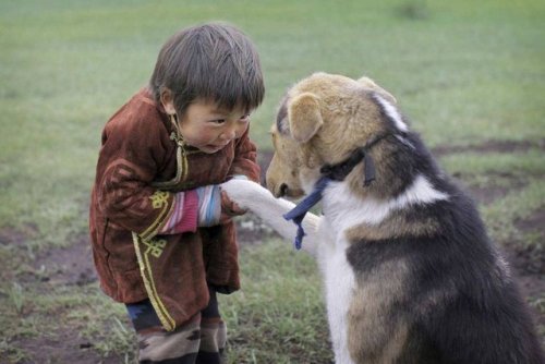 gardenofthefareast:Boy from Mongolia with pet dog © Timothy...