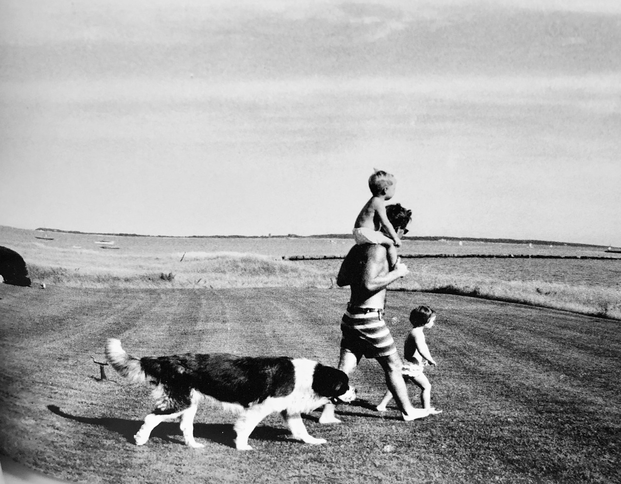 RFK, with Jr. on his shoulders, and Kathleen, walking across the Big Lawn at Hyannis Port.
