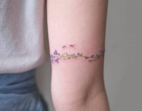 Floral bracelet tattoo on the left arm. Tattoo artist: Sol... flower;small;animal;tiny;flower bracelet;little;nature;soltattoo;medium size;illustrative;upper arm;ant;insect;band;bicep;inner arm