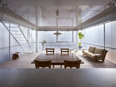 ombuarchitecture:<br /><br />House in Tousuien<br />Hiroshima • Japan<br />By Suppose Design Office<br />The House of Tousuien is located in a quiet residential area, and it is designed for a couple and 3 children. The three sides of this house are surrounded by other residence buildings, and the shape of the site forces the house to stay long and narrow.<br />Most exterior walls are thick and heavy, where windows are added to balance out the heavy look of the exterior. For the House of Tousuien, we used a thin and translucent material to replace the regular exterior walls, where natural light and be maximized in the interior space.<br />via Archdaily<br />