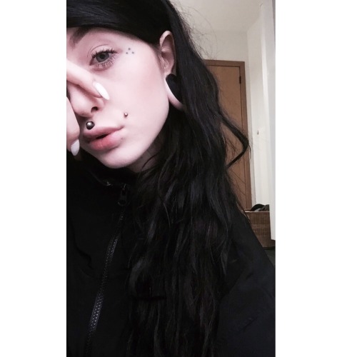 girl with tattoos my face girl with piercings girl with ink long hair pale skin blue eyes black and white black hair stretched ears stretched lobes