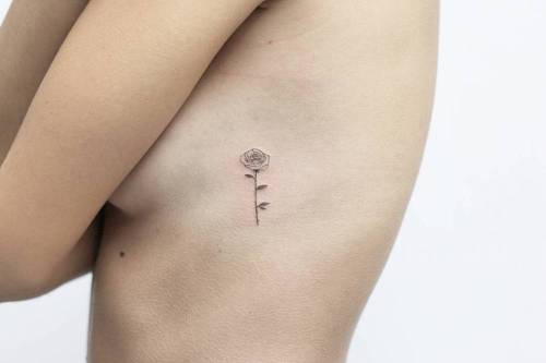 Fine line rose tattoo on the left side ribcage. Tattoo artist:... flower;fine line;small;micro;rib;tiny;rose;little;nature;lindsayapril
