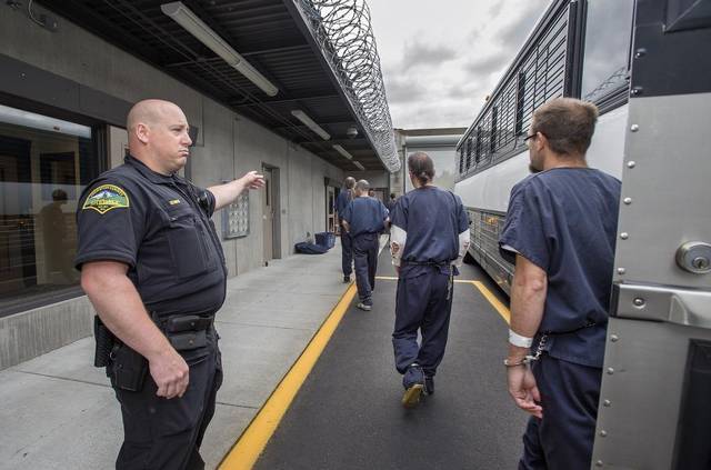 Mus1g4 — County Jail inmates dressed uniformly in blue...