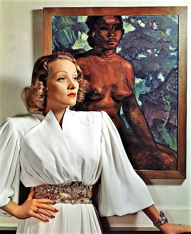 gatabella:
âA Nickolas Muray 3-color carbro portrait of actress Marlene Dietrich. Dietrich is in front of a Paul Gauguin painting in a white dress with ornate golden belt.
â