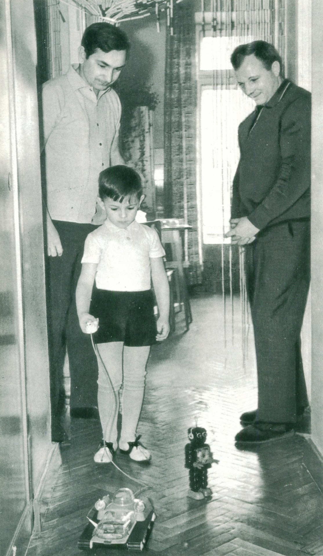 Yury Gagarin visiting cosmonaut Valery Bykovsky to celebrate his son Valerik’s 5th birthday. Valerik is playing with a toy robot and a toy planet rover - both toys hardly available for the general public.
This photo was taken shortly before Yury’s...