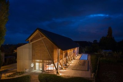 archatlas:<br /><br /><br />Hôtel des Berges’ Spa des Saules in Illhaeusern<br /><br /><br />Conceived as a contemporary reinterpretation of an Alsatian farm by the agency <br /><br />Jouin Manku, the Hôtel des Berges’ Spa des Saules <br /><br /> of 800m² reflects in its design the timber frames of the region’s large old barns, built with untreated materials the structure is built out of solid timber structure with a dark gray tiled roof, set in a concrete volume and further solidified into the ground through a smooth stone base.<br /><br /><br />Follow the Source Link for image sources and more information. <br /><br /><br />