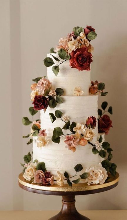 3 tier white wedding cake with cascading roses