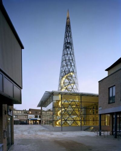 archatlas:<br /><br /><br /><br />The Glass Centre in Lommel<br /><br />The Glass Centre, Flemish Centre for Modern Art, designed by Philippe Samyn and Partners has been constructed along the length of the “De Vryheyt” passage, right in the heart of the town of Lommel. On “Dorp” square it completes the cultural ensemble formed by the Aerts house and the regional tourist centre. In the “De Vryheyt” passage, a new glass gallery links “Dorp” square with the “De Adelberg” cultural centre and its future theatre.The nature of the project required us to design a glass building, and it has been designed in such a way that the space it provides blends in seamlessly with the art it displays and produces, forming a unified whole. Furthermore, the structure emphasises the Glass Centre’s multifunctionality (education, information, services, exhibitions and glass production).