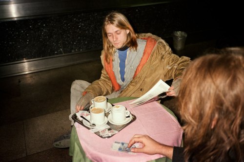 nirvananews:Kurt Cobain reading and enjoying a beverage in...