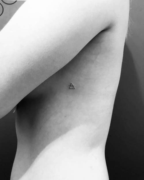 By Wicky Nicky, done at West 4 Tattoo, Manhattan.... side boob;small;air symbol;micro;symbols;wickynicky;glyphs by eight hour day;rib;tiny;ifttt;little;minimalist;alchemy;transcend symbol;glyph