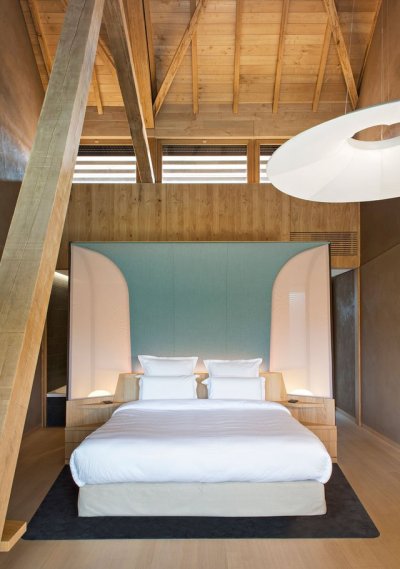 archatlas:<br /><br /><br />Hôtel des Berges’ Spa des Saules in Illhaeusern<br /><br /><br />Conceived as a contemporary reinterpretation of an Alsatian farm by the agency <br /><br />Jouin Manku, the Hôtel des Berges’ Spa des Saules <br /><br /> of 800m² reflects in its design the timber frames of the region’s large old barns, built with untreated materials the structure is built out of solid timber structure with a dark gray tiled roof, set in a concrete volume and further solidified into the ground through a smooth stone base.<br /><br /><br />Follow the Source Link for image sources and more information. <br /><br /><br />