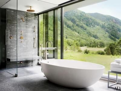 A large shower and bathtub with mountain views in Aspen, CO. [3200x2399]