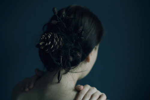 portrait emotive back hair pinecones nature dark