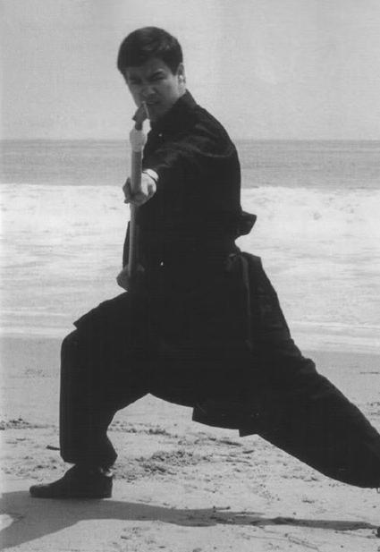 gutsanduppercuts:A young Bruce Lee practicing on the beach...