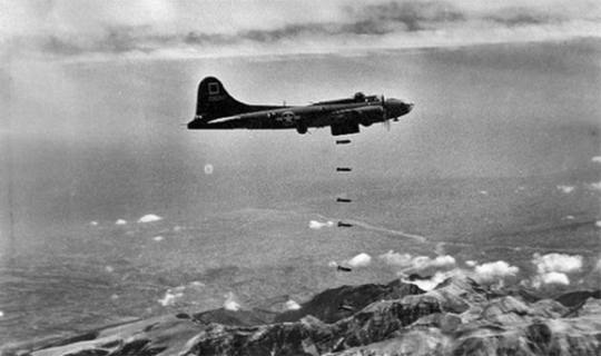 World war ll plane dropping bomb in the mountain 