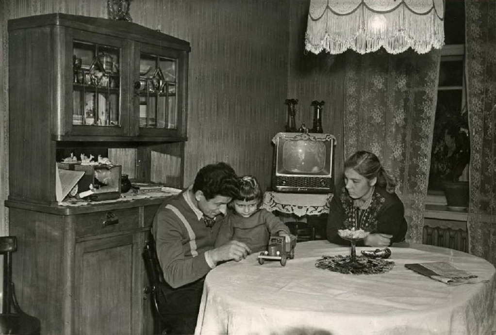 Turning machine operator Sergey Bushuyev with his wife Antonina and daughter Larisa in their home (1957)