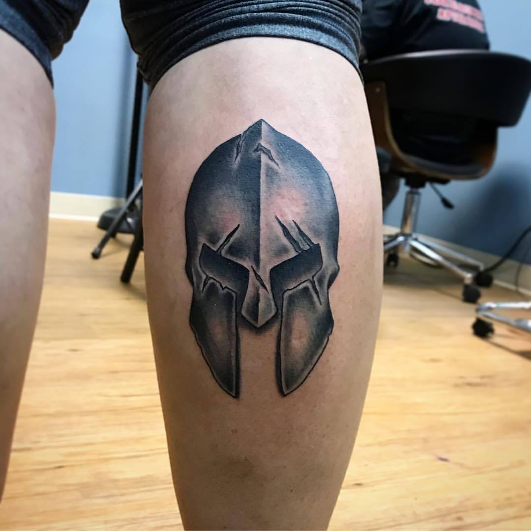 Warrior helmet spartan shield tattoo desig on shoulder. 