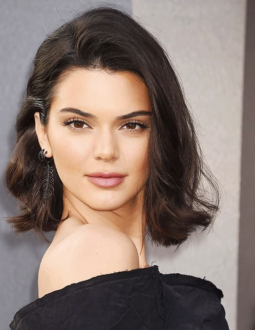 Byrdie Beauty Kendall Jenner With Short Wavy Hair And Pink Lips