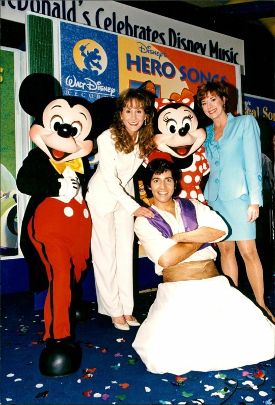 I love this photo of Jodi Benson (the voice of Ariel, left) and Paige O’Hara (the voice of Belle, right) with Mickey, Minnie and...