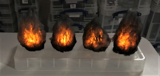 4 painted smoke markers lit up in dark