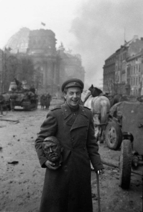 historicaltimes:A Soviet soldier with the head of a statue of...