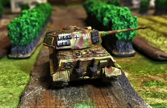 9 Tiger II moving down road, rear view