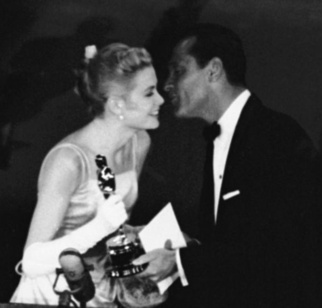 William Holden kisses Grace Kelly as he presents... - Grace & Family