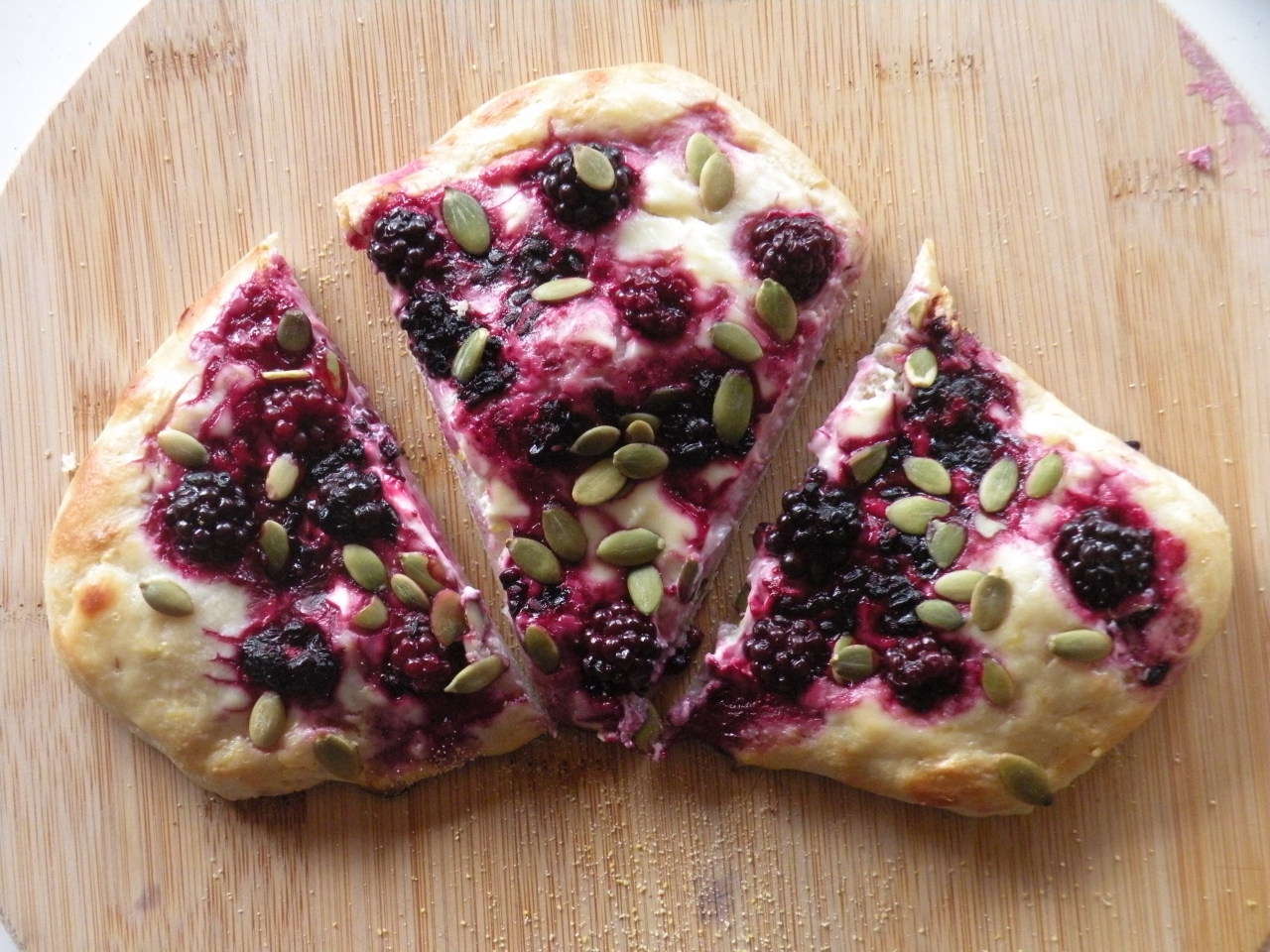 A blackberry-pepita pizza.