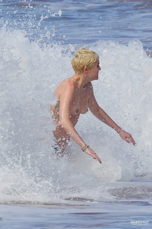 toplessbeachcelebs:Miley Cyrus (Singer) swimming topless in...