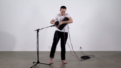 VINCENT CHEVALIER, COVER
This video explores the play between two definitions for the word “cover”. Chevalier performs a version of a song by rock singer PJ Harvey by hugging a set of speakers against his body while the music plays. This gesture...