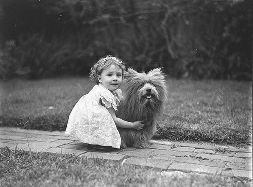 Study of a small girl with a prize Scottish terrier dog, c. 1935...