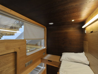 Russian architects Arch Group have completed the first of their tiny hotel rooms for napping at airports. The Sleepbox unit at Moscow’s Sheremetyevo airport contains two beds and can be rented for between 30 minutes and several hours. The pod is equipped with LED reading lamps as well as sockets for charging laptops and mobile phones.<br /><br /><br /><br />Imagine the situation where you are in a modern city, you are not a local resident, and you have not booked a hotel. It is not a comfortable situation because modern aggressive cities give you no opportunity to rest and relax. If you want to sleep while waiting for your plane or train, you face many security and hygiene problems. We believe that urban infrastructure should be more comfortable. For this purpose we have developed Sleepbox. It provides moments of quiet sleep and rest without wasting time in search for a hotel.<br /><br /><br /><br /><br /><br />Possible locations for Sleepbox include:<br /><br /><br /><br />Railroad stations<br />Airports<br />Exhibition centers<br />Public and shopping centers<br />Accommodation facilities<br />Available options include:<br /><br /><br /><br />Matted film on windows with changing transparency<br />Mood lighting – LED lamps with changing light colors<br />Built-in media block (TV, touch-screen monitor)<br />Wi-Fi router<br />Alarm, intercom<br />Safe deposit box<br />Built-in payment station with magnetic keys<br />