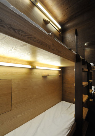 Russian architects Arch Group have completed the first of their tiny hotel rooms for napping at airports. The Sleepbox unit at Moscow’s Sheremetyevo airport contains two beds and can be rented for between 30 minutes and several hours. The pod is equipped with LED reading lamps as well as sockets for charging laptops and mobile phones.<br /><br /><br /><br />Imagine the situation where you are in a modern city, you are not a local resident, and you have not booked a hotel. It is not a comfortable situation because modern aggressive cities give you no opportunity to rest and relax. If you want to sleep while waiting for your plane or train, you face many security and hygiene problems. We believe that urban infrastructure should be more comfortable. For this purpose we have developed Sleepbox. It provides moments of quiet sleep and rest without wasting time in search for a hotel.<br /><br /><br /><br /><br /><br />Possible locations for Sleepbox include:<br /><br /><br /><br />Railroad stations<br />Airports<br />Exhibition centers<br />Public and shopping centers<br />Accommodation facilities<br />Available options include:<br /><br /><br /><br />Matted film on windows with changing transparency<br />Mood lighting – LED lamps with changing light colors<br />Built-in media block (TV, touch-screen monitor)<br />Wi-Fi router<br />Alarm, intercom<br />Safe deposit box<br />Built-in payment station with magnetic keys<br />