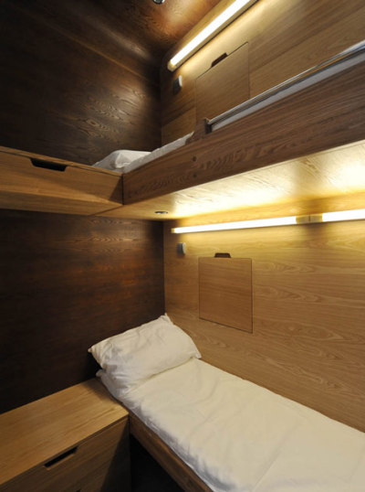 Russian architects Arch Group have completed the first of their tiny hotel rooms for napping at airports. The Sleepbox unit at Moscow’s Sheremetyevo airport contains two beds and can be rented for between 30 minutes and several hours. The pod is equipped with LED reading lamps as well as sockets for charging laptops and mobile phones.<br /><br /><br /><br />Imagine the situation where you are in a modern city, you are not a local resident, and you have not booked a hotel. It is not a comfortable situation because modern aggressive cities give you no opportunity to rest and relax. If you want to sleep while waiting for your plane or train, you face many security and hygiene problems. We believe that urban infrastructure should be more comfortable. For this purpose we have developed Sleepbox. It provides moments of quiet sleep and rest without wasting time in search for a hotel.<br /><br /><br /><br /><br /><br />Possible locations for Sleepbox include:<br /><br /><br /><br />Railroad stations<br />Airports<br />Exhibition centers<br />Public and shopping centers<br />Accommodation facilities<br />Available options include:<br /><br /><br /><br />Matted film on windows with changing transparency<br />Mood lighting – LED lamps with changing light colors<br />Built-in media block (TV, touch-screen monitor)<br />Wi-Fi router<br />Alarm, intercom<br />Safe deposit box<br />Built-in payment station with magnetic keys<br />