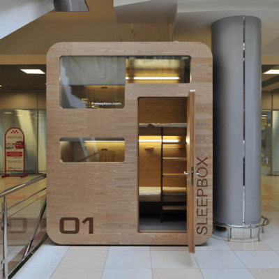 Russian architects Arch Group have completed the first of their tiny hotel rooms for napping at airports. The Sleepbox unit at Moscow’s Sheremetyevo airport contains two beds and can be rented for between 30 minutes and several hours. The pod is equipped with LED reading lamps as well as sockets for charging laptops and mobile phones.<br /><br /><br /><br />Imagine the situation where you are in a modern city, you are not a local resident, and you have not booked a hotel. It is not a comfortable situation because modern aggressive cities give you no opportunity to rest and relax. If you want to sleep while waiting for your plane or train, you face many security and hygiene problems. We believe that urban infrastructure should be more comfortable. For this purpose we have developed Sleepbox. It provides moments of quiet sleep and rest without wasting time in search for a hotel.<br /><br /><br /><br /><br /><br />Possible locations for Sleepbox include:<br /><br /><br /><br />Railroad stations<br />Airports<br />Exhibition centers<br />Public and shopping centers<br />Accommodation facilities<br />Available options include:<br /><br /><br /><br />Matted film on windows with changing transparency<br />Mood lighting – LED lamps with changing light colors<br />Built-in media block (TV, touch-screen monitor)<br />Wi-Fi router<br />Alarm, intercom<br />Safe deposit box<br />Built-in payment station with magnetic keys<br />