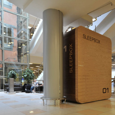 Russian architects Arch Group have completed the first of their tiny hotel rooms for napping at airports. The Sleepbox unit at Moscow’s Sheremetyevo airport contains two beds and can be rented for between 30 minutes and several hours. The pod is equipped with LED reading lamps as well as sockets for charging laptops and mobile phones.<br /><br /><br /><br />Imagine the situation where you are in a modern city, you are not a local resident, and you have not booked a hotel. It is not a comfortable situation because modern aggressive cities give you no opportunity to rest and relax. If you want to sleep while waiting for your plane or train, you face many security and hygiene problems. We believe that urban infrastructure should be more comfortable. For this purpose we have developed Sleepbox. It provides moments of quiet sleep and rest without wasting time in search for a hotel.<br /><br /><br /><br /><br /><br />Possible locations for Sleepbox include:<br /><br /><br /><br />Railroad stations<br />Airports<br />Exhibition centers<br />Public and shopping centers<br />Accommodation facilities<br />Available options include:<br /><br /><br /><br />Matted film on windows with changing transparency<br />Mood lighting – LED lamps with changing light colors<br />Built-in media block (TV, touch-screen monitor)<br />Wi-Fi router<br />Alarm, intercom<br />Safe deposit box<br />Built-in payment station with magnetic keys<br />