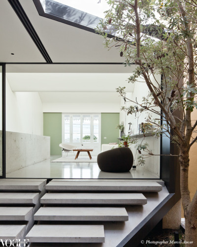 voguelivingmagazine:<br /><br />Sydney architects Chenchow Little took on the task of modernising a Victorian terrace and designed an award-winner where skylights are the highlight. Concrete steps lead up to a half level from the central courtyard to the front living room where sliding glass doors open fully to the outdoors. A wall painted in Bristol Heritage ‘Tyntynder’ is a nod to the terrace home’s Victorian origin.<br />From ‘Leading Light’, a story on page 108 of Vogue Living Jan/Feb 2012, on newsstands now. <br />Photograph by Marcel Aucar.<br />