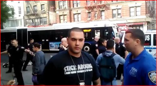 Yes, that’s a cop wearing a t-shirt that says “Stick...