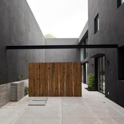 theblackworkshop:<br /><br />Wooden doors and screens stand out against the black walls of this house and courtyard in Mexico City.<br />