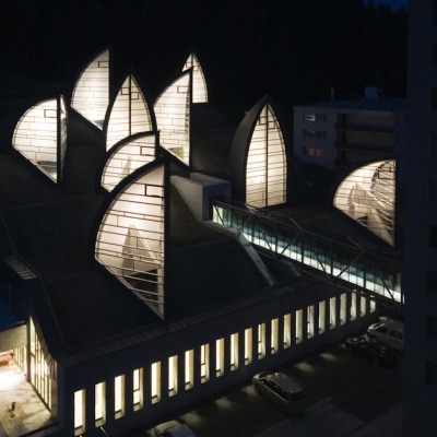 modernizing:<br /><br />Located in Arosa, Switzerland, this hotel’s wellness center was created by Architect Mario Botta with not only healing properties from within– but a beautiful piece of architecture to create positive energy from the outside as well. Built in 2006, this gorgeous Tschuggen Grand Hotel and Wellness Centre (or Berg Oase) is mainly level with the ground with the exception of the metaphorical trees that stick up and protrude through the deep snow in the winter months. Discreet integration was a main concern of the planning, and a glazed walkway connects the centre with the hotel– keeping things clean and continuous. At night the Berg Oase becomes a magically lit place, showing the life and ongoings within.